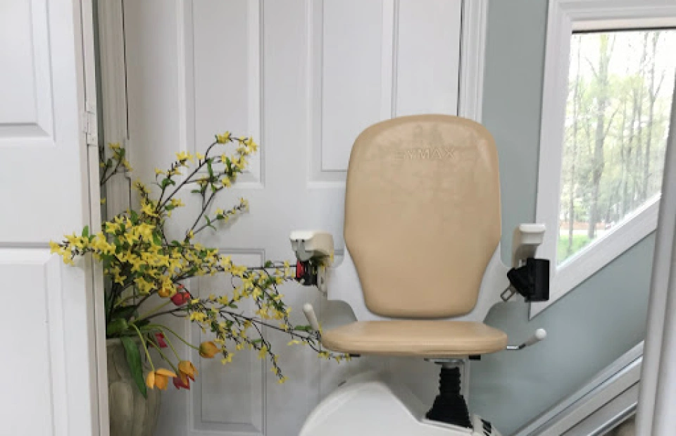 white stairlift chair with carton brown chair cover in front of a white door